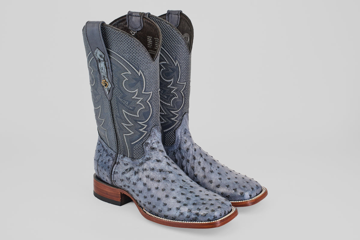Exotic Full Quilt Ostrich boots in Safari Gray feature decorative stitching, square toes, and brown wooden heels, displayed on a light background.