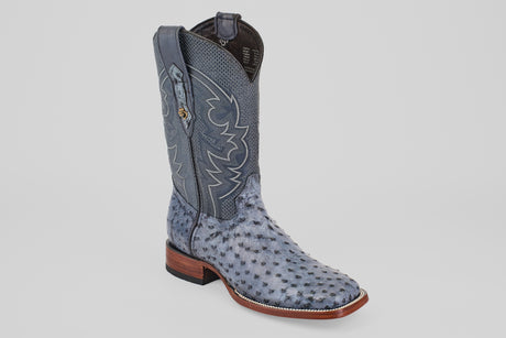 The Exotic Full Quilt Ostrich - Safari Gray - Square Toe boot features decorative stitching, a square toe, and a brown wooden heel, shown against a plain white background.