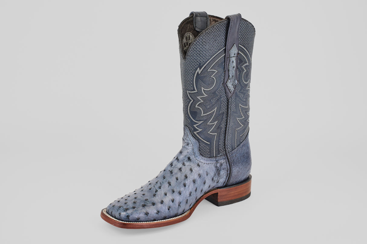The Exotic Full Quilt Ostrich - Safari Gray - Square Toe boot features textured ostrich leather, decorative shaft stitching, a square toe, and a wooden heel, shown on a plain light background.