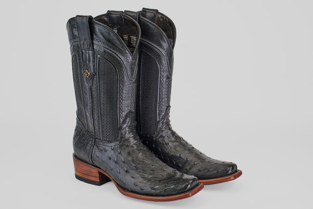 The Exotic Ostrich - Black - Narrow Square Toe boots feature textured ostrich leather, decorative stitching, wooden heels, and a narrow square toe, displayed against a plain light gray background.