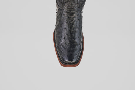 A top-down view of the Exotic Ostrich - Black - Narrow Square Toe boot, featuring a textured leather pattern and brown sole.