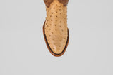 The Exotic Full Quilt Ostrich - Orix features tan ostrich leather with round toe, brown welt stitching, and full quill bumps—showcasing handcrafted Western quality. Photographed from above on a white background.