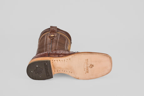 The Exotic Full Quilt Ostrich - Brown - Square Toe boot features a textured upper, smooth sole with TEXAS COUNTRY branding, a black textured heel, and classic cowboy style—ideal for square toe boot fans.