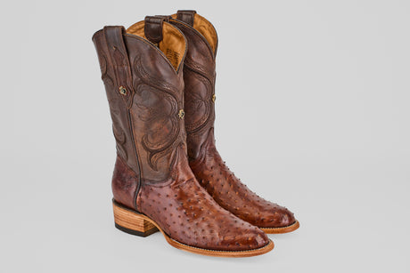 The Austin - Tabaco - Roper Toe men's cowboy boots, made from brown ostrich leather with classic roper toes, detailed stitching, and wooden heels, are displayed side by side on a light gray background.