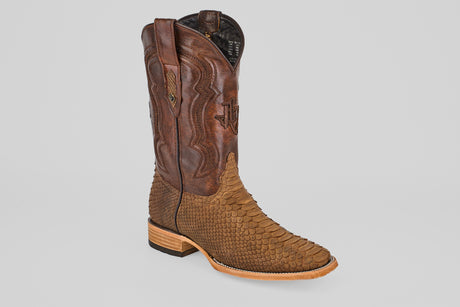 The Tanner - Tamarindo - Square Toe boot features a brown upper with decorative stitching, Python Tamarindo textured snakeskin lower half, a pointed toe, and a low stacked wooden heel, displayed against a plain light background.