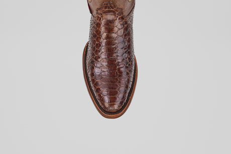 A close-up, top-down view of the toe of the Tanner - Brown - Round Toe shoe, featuring brown leather with a textured Python Cafe Oval pattern, set against a plain white background.