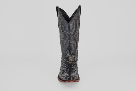 The Tanner - Black - Round Toe cowboy boot, shown front-facing on a plain light background, features intricate stitching and a textured reptile-like pattern in Python Negro Oval leather.