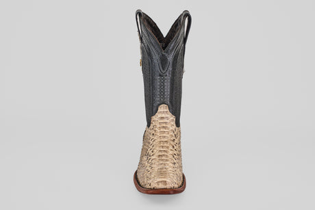 The Tanner - Natural - Narrow Square Toe is a Western-style cowboy boot with a light tan, textured exotic-look lower and a contrasting dark shaft, both featuring decorative stitching.