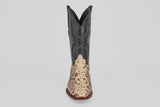 The Tanner - Natural - Roper Toe cowboy boot features a natural tan python snakeskin lower section and a black leather upper with detailed stitching, shown upright against a plain light background.