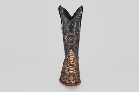 The Tanner – Rustic Bone – Snip Toe is a western-inspired boot featuring a black upper, brown textured lower section, star emblem on the front shaft, and a snip toe, shown from the front on a plain white background.