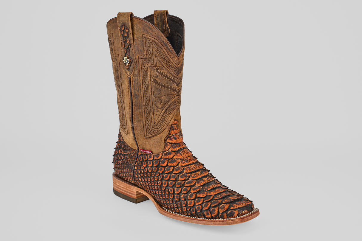 The Tanner Jumbo – Chestnut – Square Toe features a brown leather upper, an orange and black python-print lower, decorative stitching, a wooden heel, and brings bold western style to your boots collection.