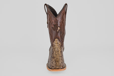 The Tanner – Dune – Square Toe boot features a brown, western-inspired design with a reptile-patterned toe and a stitched Texas outline on the shaft, shown from the front against a plain light background.