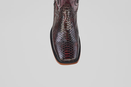 A top-down view of a single, square-toe, dark brown snakeskin cowboy boot—Tanner - Black Cherry - Square Toe—on a plain white background.