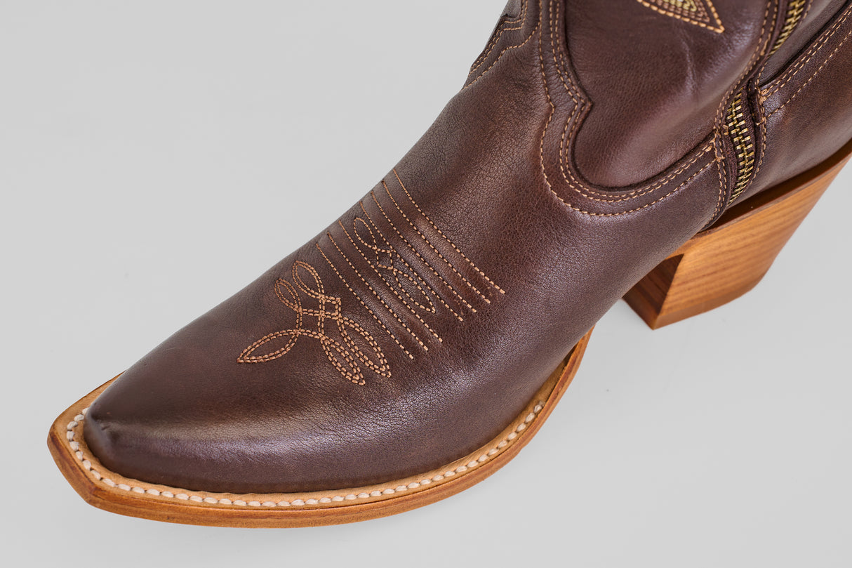 A close-up of the Allison Dark Moka - Tall Shaft - Snip Toe boot shows its decorative stitching, dark mocha leather, pointed toe, and light wooden heel—ideal for anyone seeking stylish women's cowboy boots.
