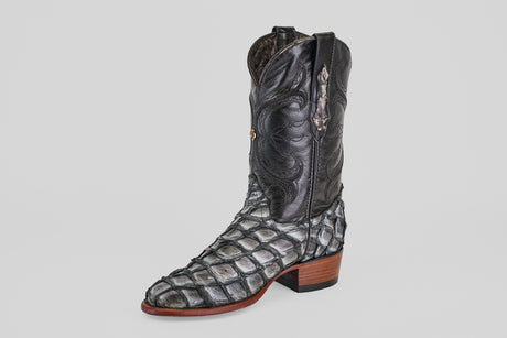 The Conor - Newspaper - Roper Toe is a single black exotic leather boot with a textured reptile-like pattern, wooden heel, and white stitching, shown against a plain light background.