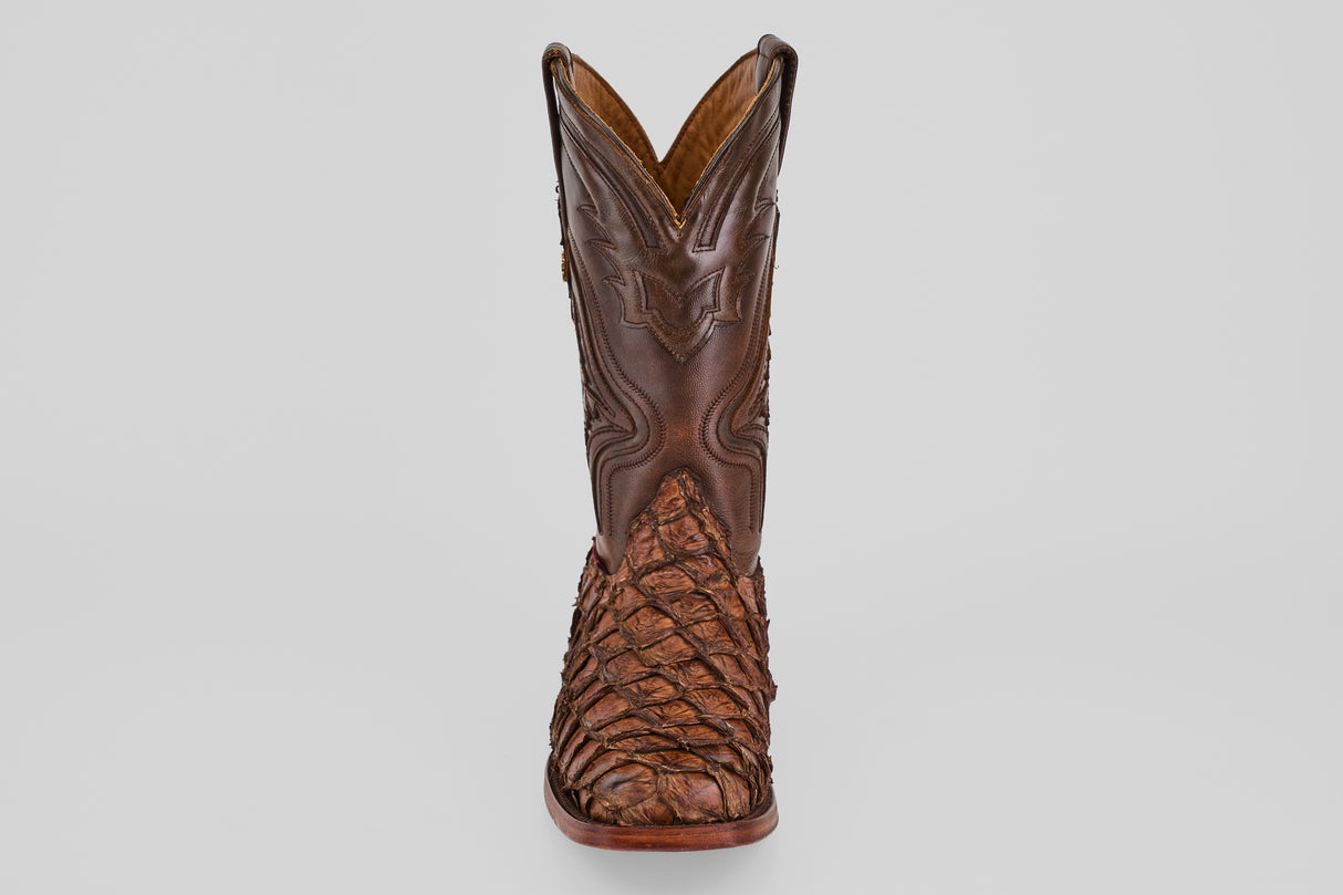 The Conor - Brown - Rodeo Toe boot is shown from the front against a plain white background, featuring detailed stitching on the shaft and a textured, patterned foot.