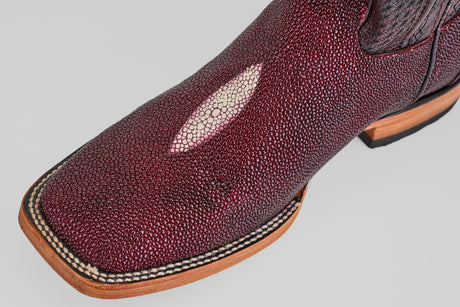Close-up of Ranger – Wine – Square Toe boots in maroon stingray leather with a textured, pebbled surface, signature pale oval patch on top, and a light-colored stitched sole.