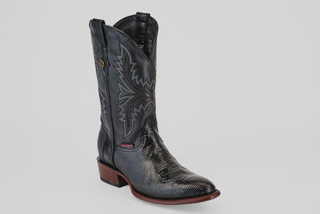 The Blaze – Black – Round Toe cowboy boot features decorative stitching, a round toe, low wooden heel, and side pull straps, displayed solo on a white background—a modern take on the timeless black cowboy boot style.