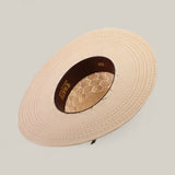 The 30X Hexagon - Open Crown is a beige, wide-brimmed straw hat featuring intricate patterns and an open lace crown, viewed from above against a light background.
