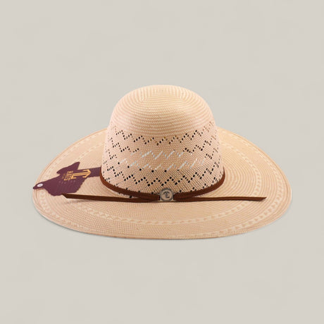 The 30X Zig Zag - Open Crown is a wide-brimmed, light tan straw hat with decorative cut-out patterns, brown hatband, round metal emblem at the front, and maroon side tag. Ideal for unique style seekers. Shown on a plain background.