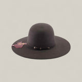 The 10X - Oxford - TC Hats is a dark brown felt Western hat with a wide brim, simple band, pink tag, and shapeable crown, shown against a plain light background.