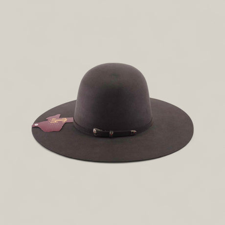 The 10X - Oxford - TC Hats is a dark brown felt Western hat with a wide brim, simple band, pink tag, and shapeable crown, shown against a plain light background.