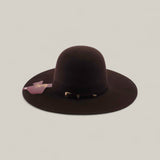 The 10X - Chocolate - TC Hats is a wide-brimmed, dark brown felt Western hat featuring a decorative band and attached tag, shown against a plain light background.