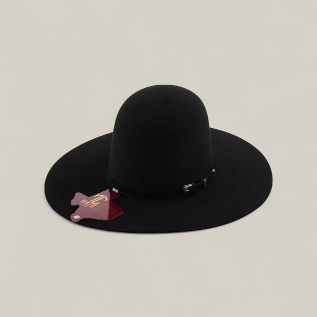 The 10X - Black - TC Hats is a wide-brimmed, black felt Western hat featuring an elegant decorative band and a red tag, showcased on a plain light gray background.