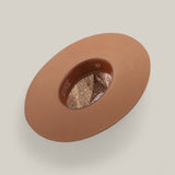 The 4X - Fawn - TC Hats Western hat, shown from above, displays its wide brown brim, inner band, and floral-patterned fabric lining against a plain light beige background.