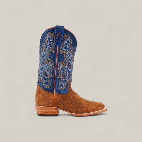 The Buck - Camel - Square Toe is a mens suede boot with a brown foot and a tall, royal blue shaft with colorful embroidery, featuring a stylish square toe and low wooden heel.
