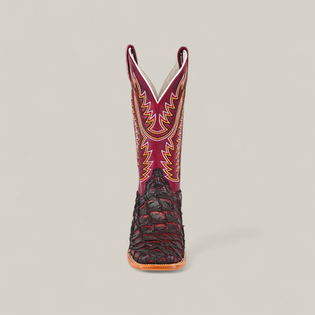 The Maverick - Wild Cherry - Square Toe boot features a dark brown textured lower, a red upper shaft with yellow and orange stitching, and a square toe, displayed facing forward against a plain light background.