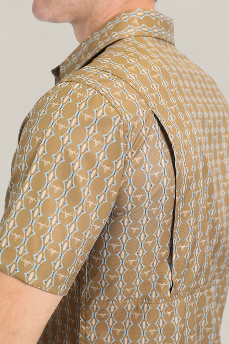 A close-up side view of a person wearing the Mens Performance Western Short Sleeve Aztec Print Camel Shirt (PGW10645), featuring short sleeves and a zippered side vent that opens to reveal the mesh lining underneath.