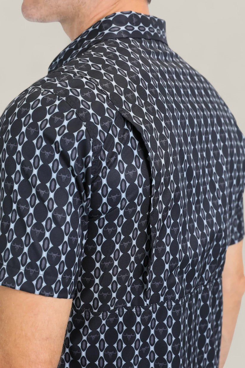 A close-up of the Mens Performance Western Short Sleeve Aztec Print Navy Shirt (PGW10646), focusing on the back and shoulder to highlight the vented flap and geometric navy Aztec print design.