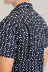 A close-up of the Mens Performance Western Short Sleeve Aztec Print Navy Shirt (PGW10646), focusing on the back and shoulder to highlight the vented flap and geometric navy Aztec print design.