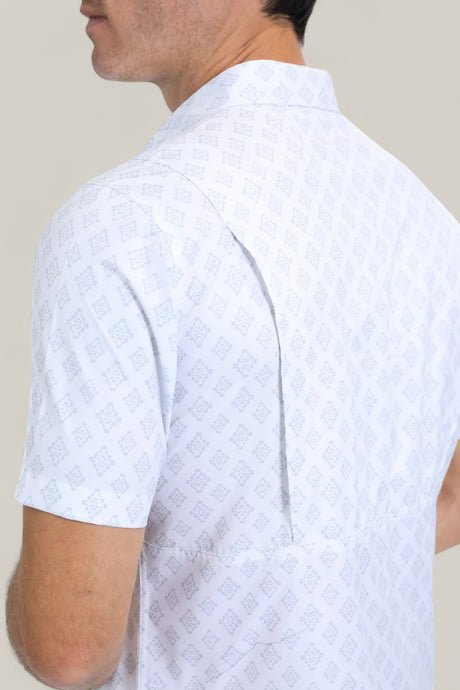 A man is seen from the back and side wearing the Mens Performance Western Short Sleeve Aztec Print White Shirt (PGW10631), featuring a collar, single back pleat, and light blue geometric pattern against a plain light background.