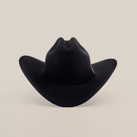 The 10X Jerarca Black, a handcrafted cowboy hat with a wide brim and high crown, is centered on a plain white background, epitomizing traditional western headwear.