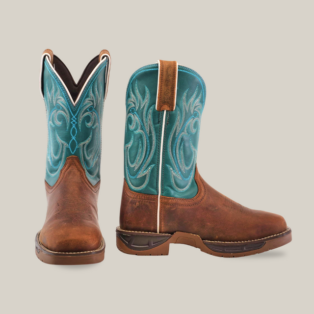 The Rustic Turquoise Brown boots are handcrafted with brown premium cowhide leather foot, a turquoise shaft, and intricate white stitching. One boot faces forward while the other side highlights the pull tab and exquisite design.