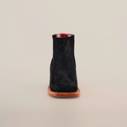 The Prime Suede Black Square Toe, a black suede ankle boot with a cowboy flair featuring a square toe and brown leather sole, is photographed from the front against a plain white background.