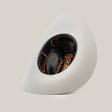 The 1000X Imperial Platinum is a modern, asymmetrical white hat with a wide brim, exuding sophistication. Its interior features stylish black and orange patterns, redefining the essence of a classic Western hat against a plain white background.