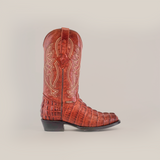 A Crocodile Tail Print Cogñac - Round Toe cowboy boot crafted from brown cowhide leather with intricate shaft stitching on a plain white background.