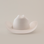 The 6X Real White is a luxurious cowboy hat, skillfully handcrafted by artisans, featuring a wide brim and creased crown set against a plain white background.