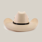 The 500X Bull Straw Hat embodies Western elegance with its cream color, wide brim, and tall pinched crown. Accented by a genuine leather band at the crowns base, it rests gracefully on a plain white background.