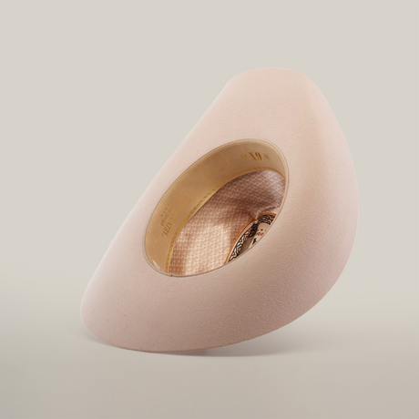 The 6X Country Belly is a plush, cream egg-shaped chair made from premium sheep wool. It features a large oval cutout showcasing a patterned interior and circular seating. Its minimalist modern design stands out against a white background.