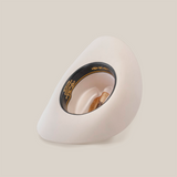 The 10X Jerarca White, a white wide-brimmed fur felt hat, is turned upside down displaying a black inner band with gold text. Inside rests a brown wooden hammer with a light handle, blending timeless western charm and functionality.