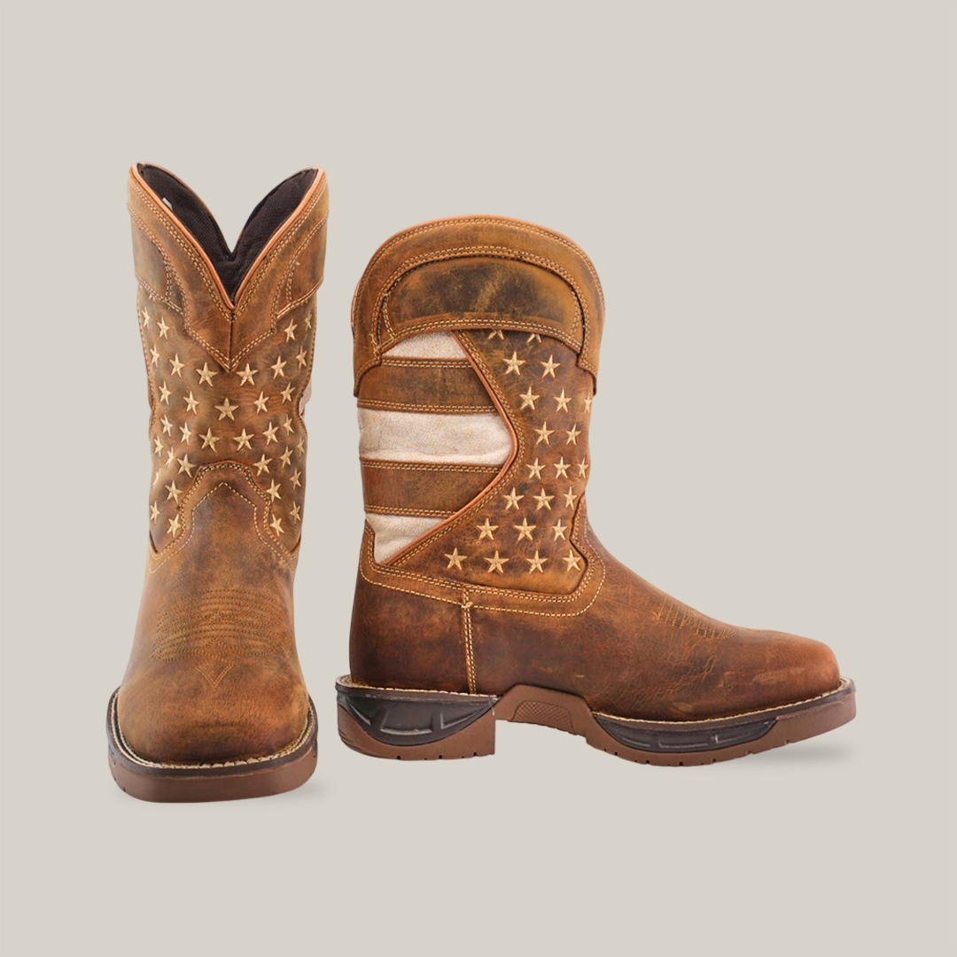 A pair of White Tan US Flag cowboy boots, handcrafted from cowhide leather, featuring star embellishments and an American flag on the shafts, designed with a soft toe and dark soles.
